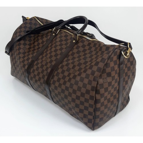 8 - A Louis Vuitton Checked Canvas Keepall Bag. Monogram Canvas and leather exterior. Comes with a shoul... 