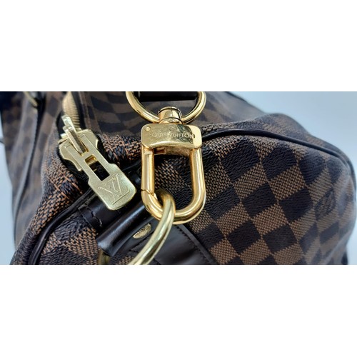 8 - A Louis Vuitton Checked Canvas Keepall Bag. Monogram Canvas and leather exterior. Comes with a shoul... 