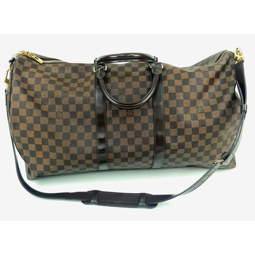 8 - A Louis Vuitton Checked Canvas Keepall Bag. Monogram Canvas and leather exterior. Comes with a shoul... 