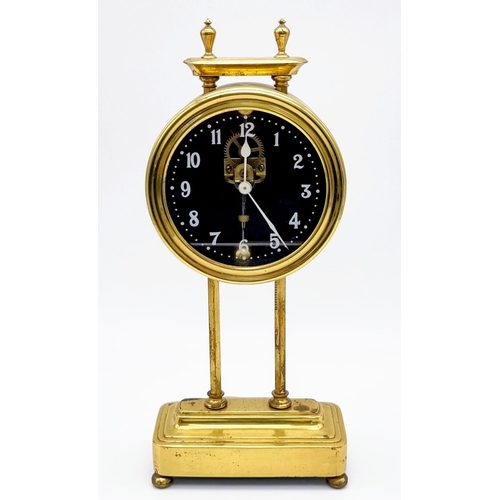 101 - A 1920s Gilded Gravity Table Clock. Skeleton dial. In full working order but because of age no guara... 