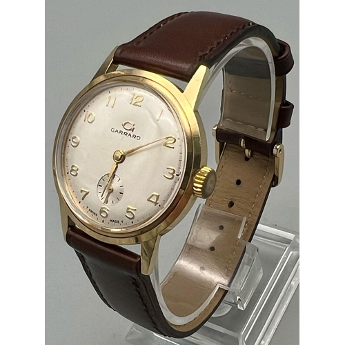 23 - A 9K Yellow Gold Vintage Garrad Gents Watch. Leather strap. 
Gold Case - 35mm. Silver tone dial with... 