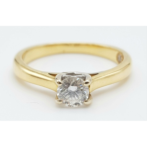 106 - An 18K Yellow Gold Diamond Solitaire Ring - With LEO certificate. Centre round cut stone - 0.34ct. H... 