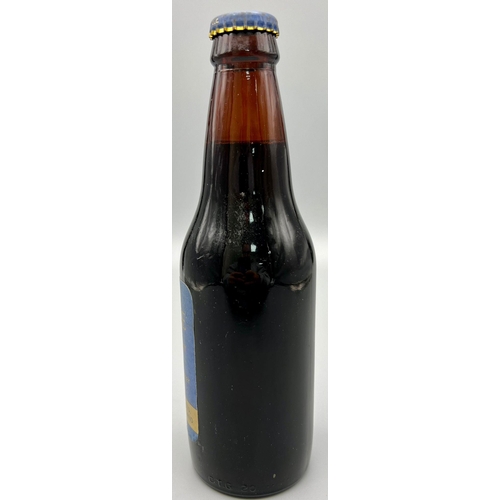 1183 - A 1977 Bottle of Jubilee Ale - Brewed by Greene King and Sons Ltd. 20cm tall.