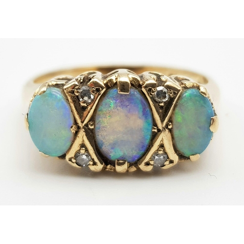 468 - A Vintage 9K Yellow Gold Opal and Diamond Ring. Three exquisite oval cut opals take centre stage. Si... 