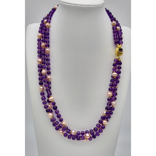 153 - A very feminine, three row necklace with round amethysts and pink, genuine, cultured pearls, with an... 