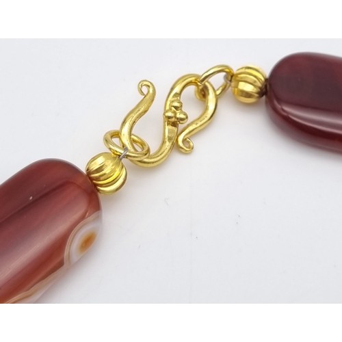 195 - A very attractive, honey coloured, banded agate necklace and earrings set with big beads (40 mm long... 