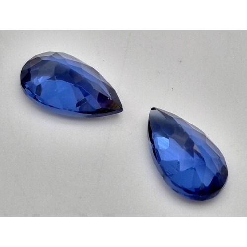 188 - A pair of pear cut, royal blue, tanzanite crystals. Dimensions: 16.11 x 9.62 x 6.74 mm and 16.39 x 9... 