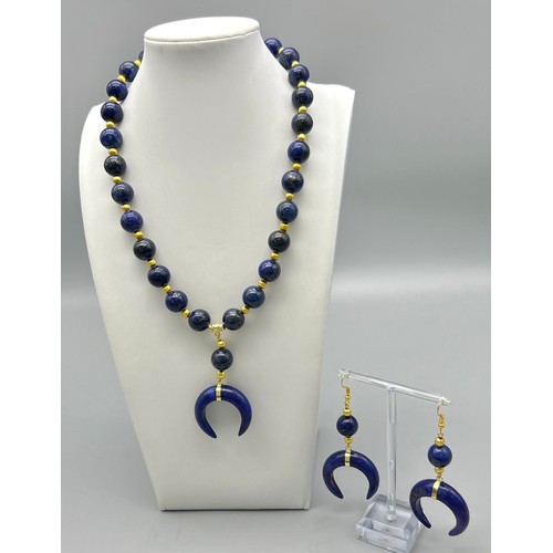 237 - A fashionable and unusual lapis lazuli necklace and earrings set with crescent carved pendants. Neck... 