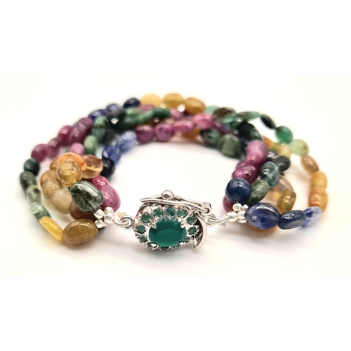 1321 - A five strand multi-gem bracelet with a silver clasp with 
 emeralds. Gems include: emeralds, rubies... 