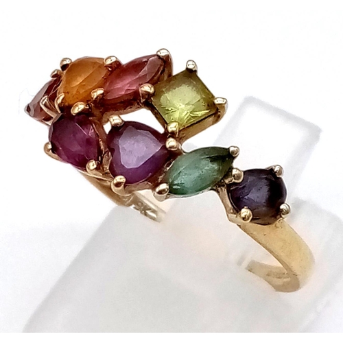 1010 - A 9K Yellow Gold Multi-Coloured Gemstone Ring. Size Q.
2.15g total weight.