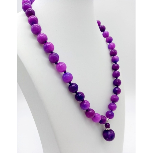 494 - A Purple Sugilite Round Beaded Necklace and Pendant. 2 and 42cm. 10mm beads.