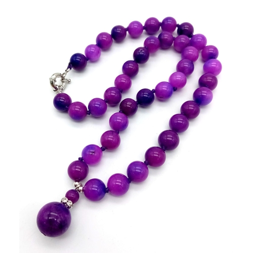 494 - A Purple Sugilite Round Beaded Necklace and Pendant. 2 and 42cm. 10mm beads.