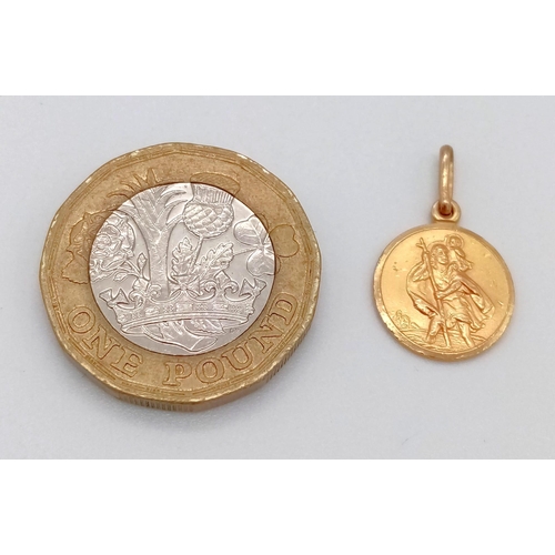 1029 - A 9K Yellow Gold St Christopher Pendant. 1.25g. 12mm diameter.