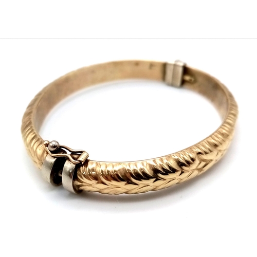 39 - A Vintage 9K Yellow Gold Bangle. Clasp opens. Decorative exterior. 6cm inner diameter. 8.96g