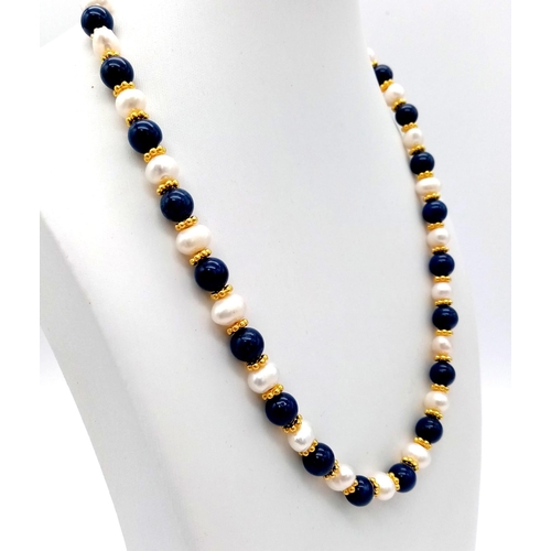 695 - A Freshwater Peral and Lapis Lazuli Necklace. Gilded spacers and clasp. 44cm