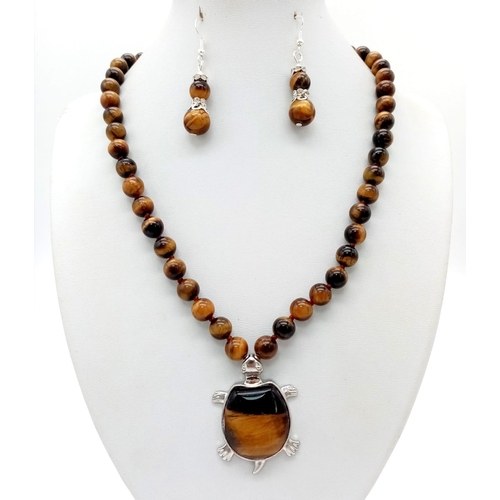 876 - A Tigers Eye Jewellery Set Comprising of: Necklace with tortoise shaped pendant. A pair of drop earr... 