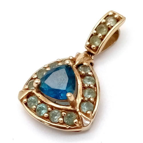 1014 - A Mexican 10K Yellow Gold and Blue Topaz Pendant. 25mm with attachment. 2.06g total weight.