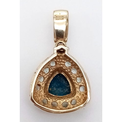 1014 - A Mexican 10K Yellow Gold and Blue Topaz Pendant. 25mm with attachment. 2.06g total weight.