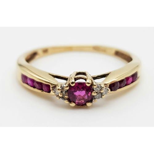 1013 - A 9K Yellow Gold Ruby and Diamond Trilogy Ring with Ruby Accents. Size O. 1.88g total weight.