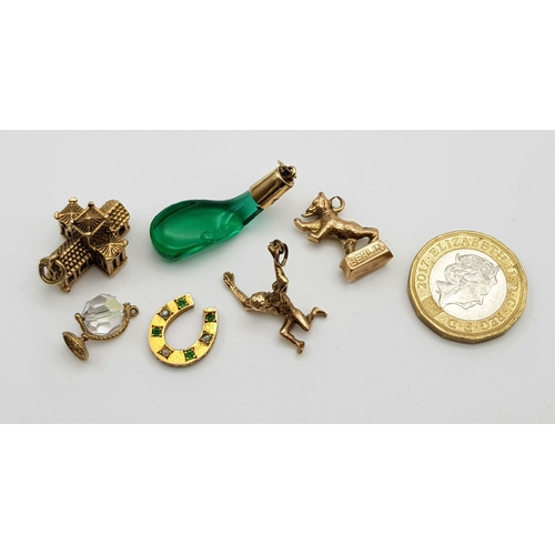 333 - A Collection of 9k Yellow Gold Charms - To include: A Victorian Emerald and pearl horseshoe charm. A... 