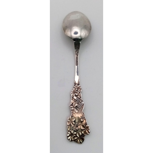 415 - AN ANTIQUE SILVER DECORATIVE TEASPOON MADE IN BRAZIL AND USING THE SWASTIKA WHEN IT DENOTED PEACE AN... 