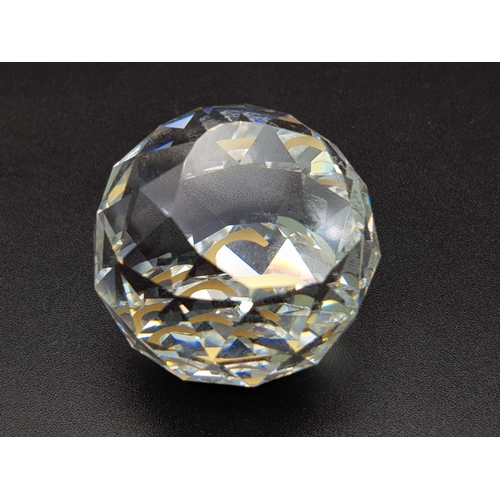 429 - A SWAROVSKI CRYSTAL CUT GLASS PAPERWEIGHT IN ORIGINAL BOX. 89.9gms   4cms diameter