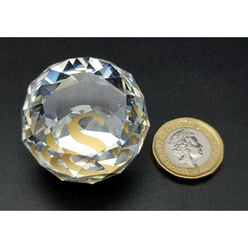 429 - A SWAROVSKI CRYSTAL CUT GLASS PAPERWEIGHT IN ORIGINAL BOX. 89.9gms   4cms diameter