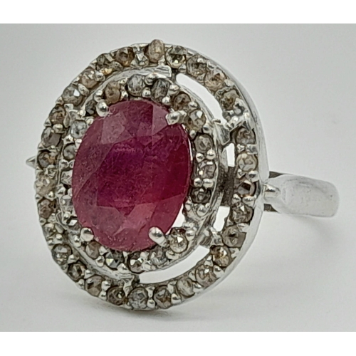 1046 - A 6ct Ruby Gemstone Ring with Halo of Two Rows of Rose Cut Diamonds. Size N. 6.96g total weight.