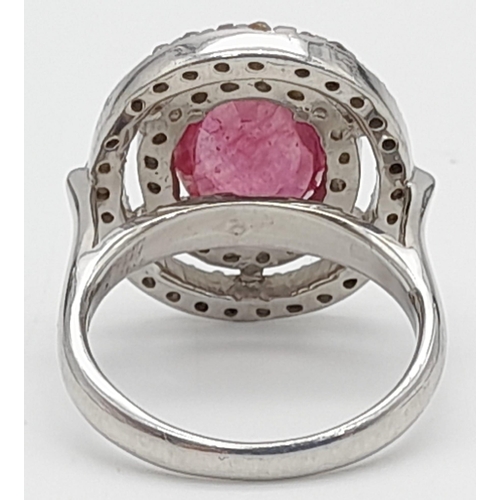 1046 - A 6ct Ruby Gemstone Ring with Halo of Two Rows of Rose Cut Diamonds. Size N. 6.96g total weight.