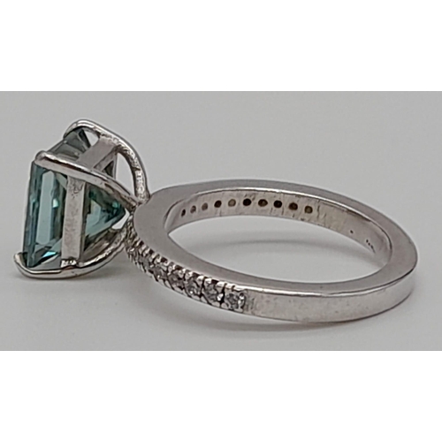 1058 - A 4ct Princess Cut Blue Moissanite Ring set in 925 silver. Size N 1/2. 5.5g total weight