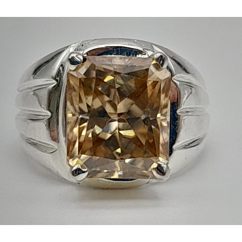 1060 - A 10.7ct Emerald Cut Champagne Moissanite Gents Ring set in 925 Silver. Size P. 12g total weight.