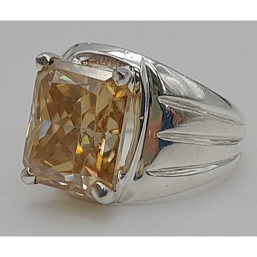 1060 - A 10.7ct Emerald Cut Champagne Moissanite Gents Ring set in 925 Silver. Size P. 12g total weight.