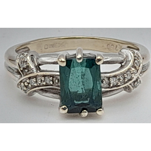 1231 - A 9K Gold Green Tourmaline Ring with Diamond Accents. Size K. 3.35g total weight.