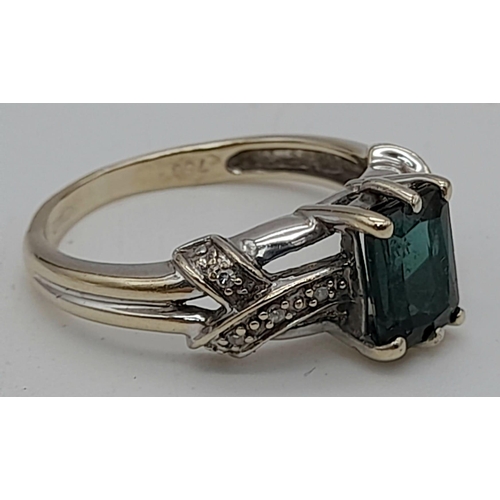 1231 - A 9K Gold Green Tourmaline Ring with Diamond Accents. Size K. 3.35g total weight.