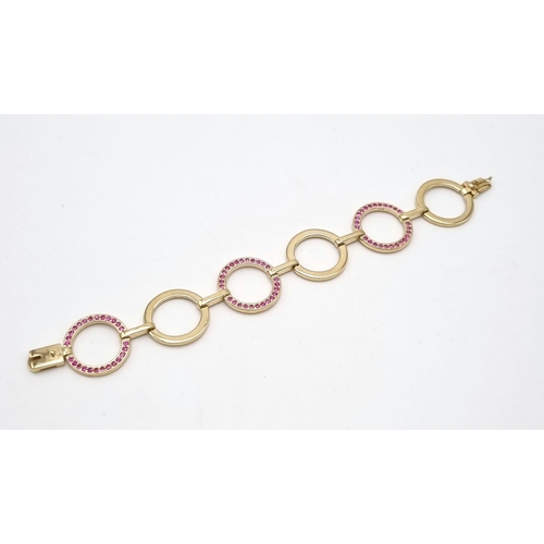 129 - A Gorgeous 9K Yellow Gold Pink Sapphire Circlet Bracelet. 78 round cut pink sapphires.  17cm. 22.95g... 