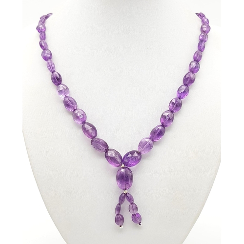 1313 - A 110ct Amethyst Tumble beads necklace with drop pendant.
42 and 5cm.