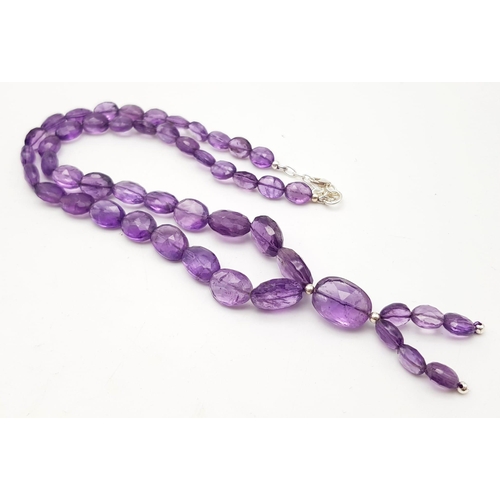 1313 - A 110ct Amethyst Tumble beads necklace with drop pendant.
42 and 5cm.