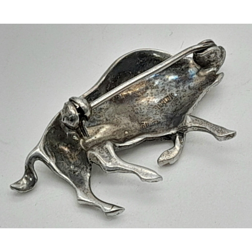 423 - A SOLID SILVER AND MARCASITE WILD BOAR BROOCH WITH AN EMERALD EYE.  5.6gms