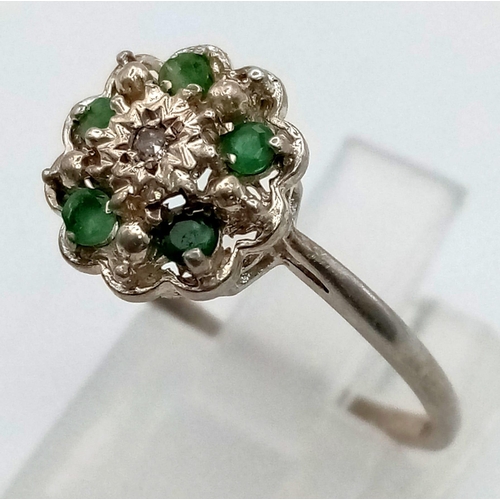 635 - A Silver Emerald and Diamond Ring. Size O 1/2.