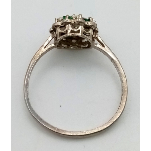 635 - A Silver Emerald and Diamond Ring. Size O 1/2.