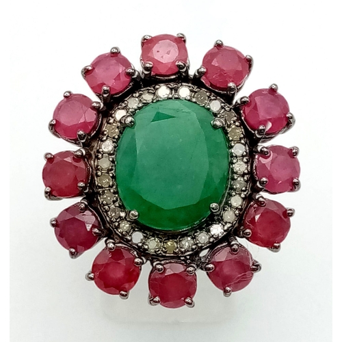 1138 - A 6.85ct Emerald Gemstone Ring with a Halo of Rubies 8.70ct and Diamonds .44ct. Size N. 14g total we... 