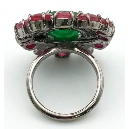 1138 - A 6.85ct Emerald Gemstone Ring with a Halo of Rubies 8.70ct and Diamonds .44ct. Size N. 14g total we... 