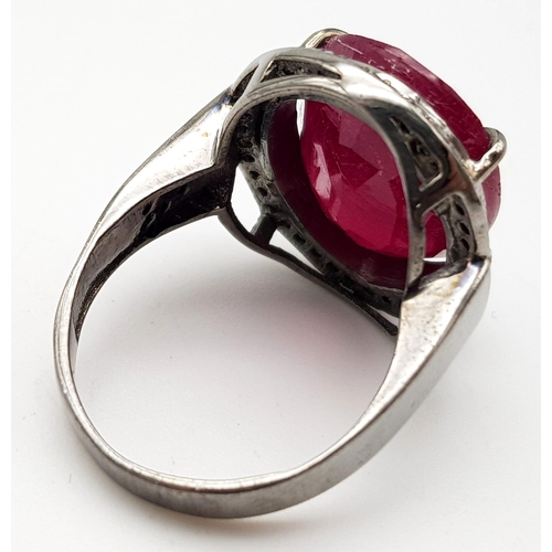 1280 - A 15.10ct Ruby Gemstone Ring - with .36ct Diamonds in a halo setting. 925 Silver. 8g total weight. S... 