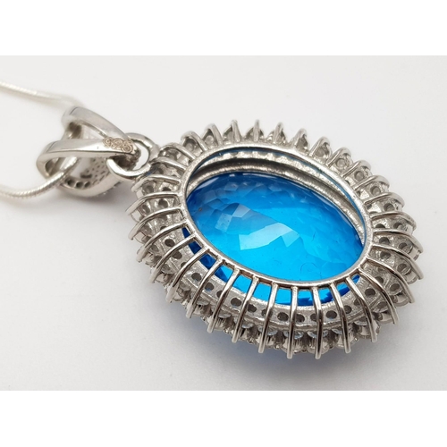 925 - A Well-Faceted Blue Topaz Pendant with a Halo of 2.5ct Diamonds approx. Topaz -20ct. Come  on a slim... 