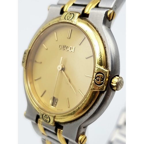 1030 - A Stylish Unisex Gucci Quartz Watch. Two tone stainless steel strap and case - 33mm. Gilded dial wit... 