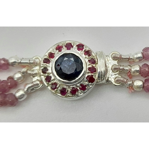 1130 - A 166ct, 3 row pink sapphire bead necklace with a sapphire and ruby clasp set in 925 silver. 40-44cm... 