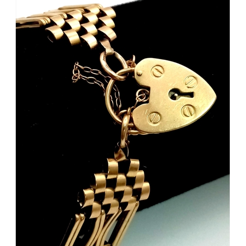 1255 - A Vintage 9K Yellow Gold Fancy Gate Brick Design Bracelet. Heart padlock and safety chain. 20cm. 27.... 