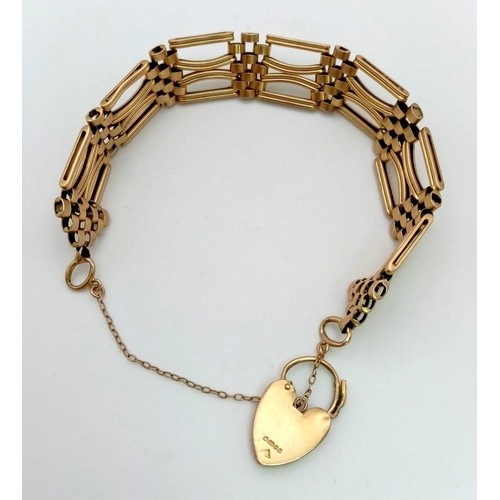 1255 - A Vintage 9K Yellow Gold Fancy Gate Brick Design Bracelet. Heart padlock and safety chain. 20cm. 27.... 