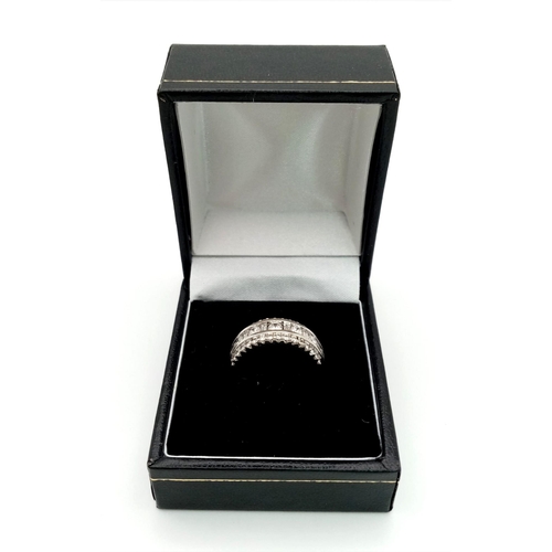 1145 - White gold round diamond ring set in a sweeping style with round diamonds in the centre. very elegan... 