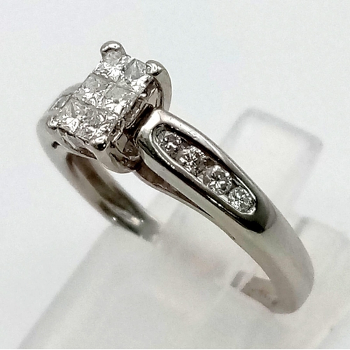 1083 - A Platinum 950 Diamond Ring. Six princess cut diamonds in centre cluster with four diamond accents o... 